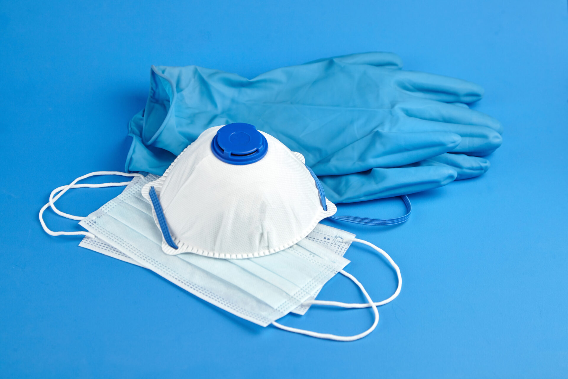 Respirator, medical sanitary surgical masks and rubber gloves on